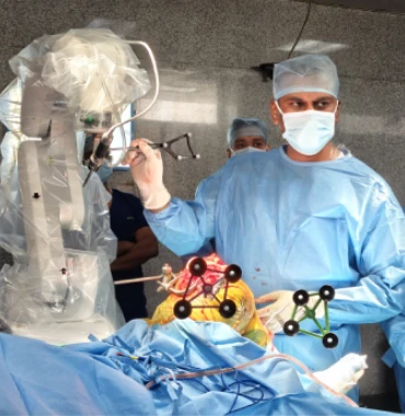 Dr. Sathish Kumar S performing robotic-assisted knee replacement surgery